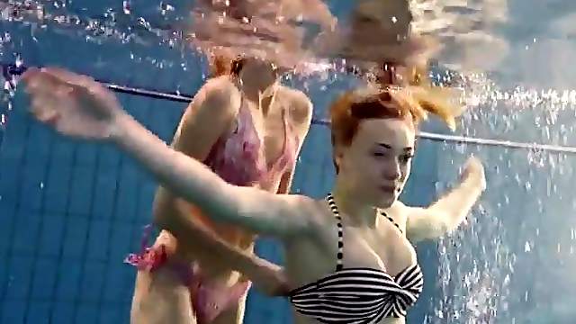 Beauties swim together in an underwater scene