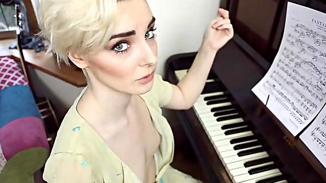 Piano playing British girl has her small tits exposed