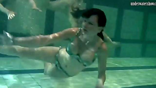 Three naked chicks have fun in the pool